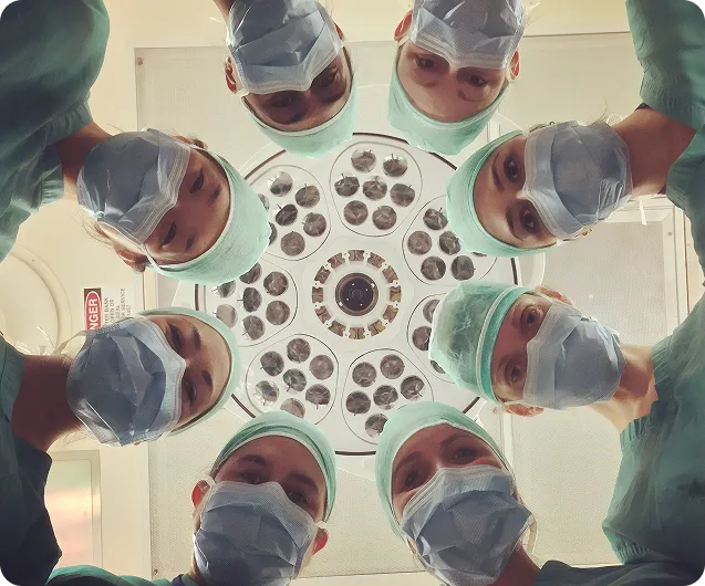 Doctors standing around a surgery patient